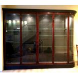 AN EARLY 20th CENTURY MAHOGANY LARGE SHOP DISPLAY CABINET, with moulded cornice, rounded at the