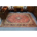 A modern Kashan carpet of crimson ground, with centre medallion & all-over floral design within