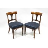 A set of five William IV mahogany bow-back dining chairs with pierced splats, padded seats, & on