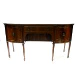 A regency style mahogany bow-front sideboard fitted frieze drawer  above a tambour shutter, a