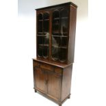 An early Victorian mahogany bookcase fitted three adjustable shelves enclosed by pair of glazed