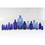 Seventeen various blue glass bottles.