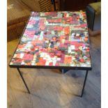 A 1970s mosaic iron legged table. a/f ne