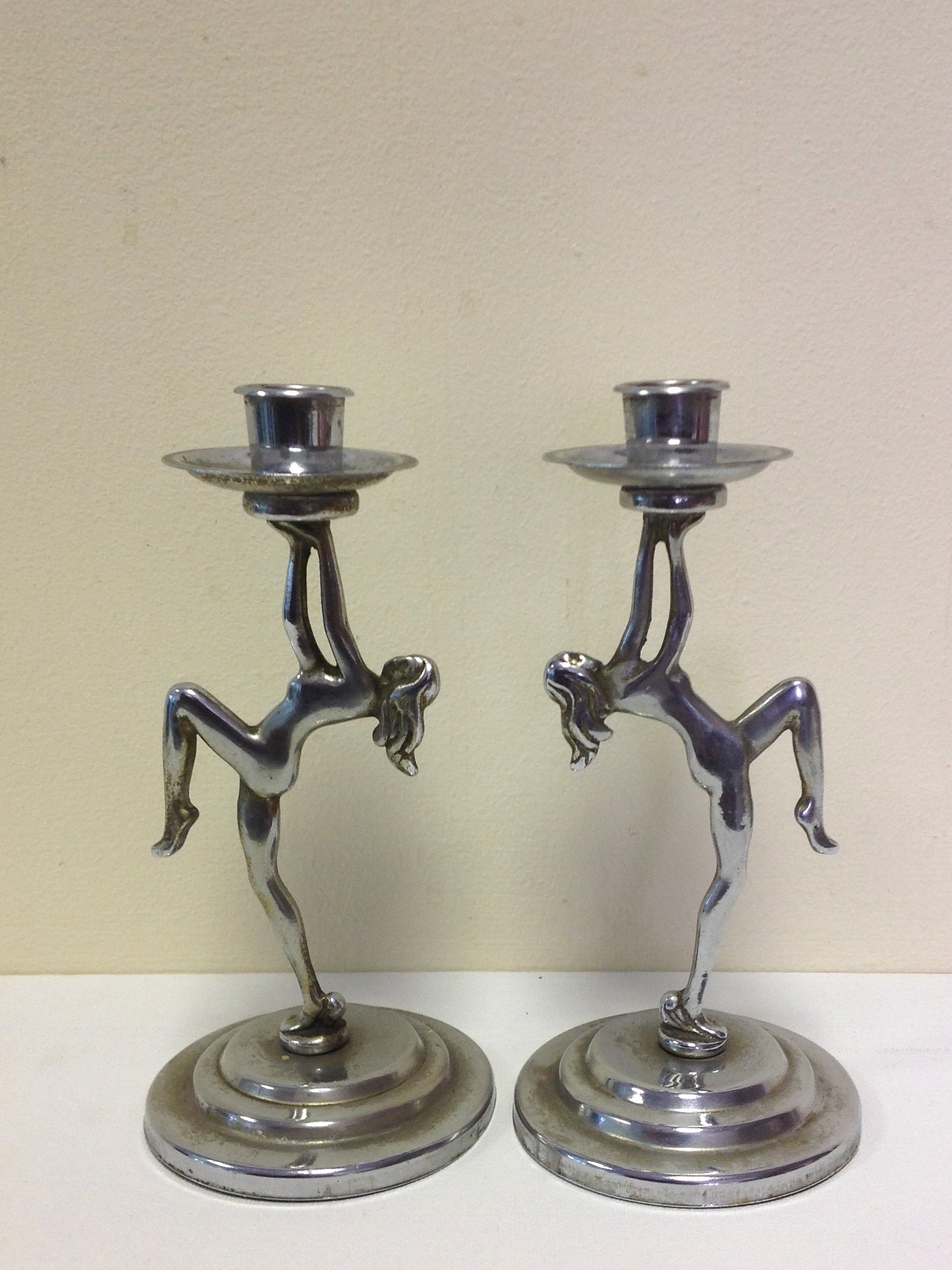 A pair of female form candle sticks. H18