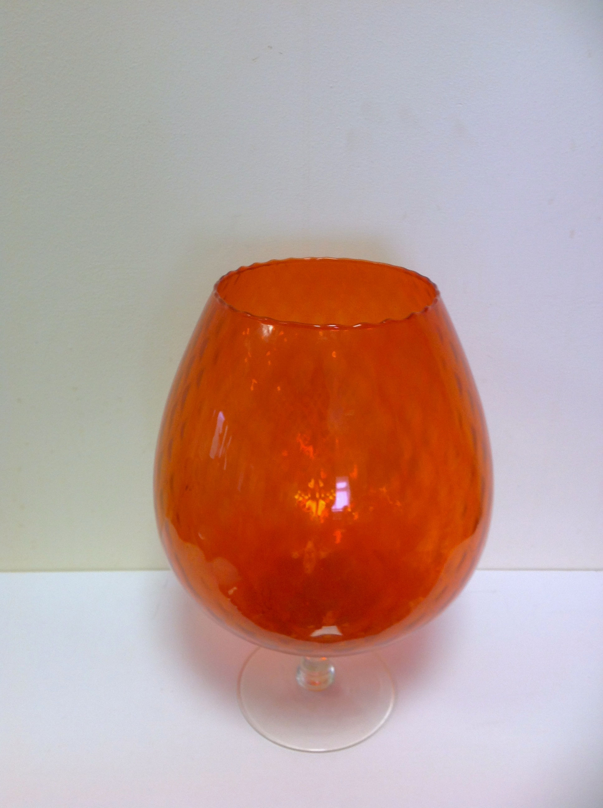 A large orange coloured glass, balloon s