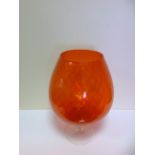 A large orange coloured glass, balloon s