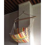 A striped hanging hammock chair.