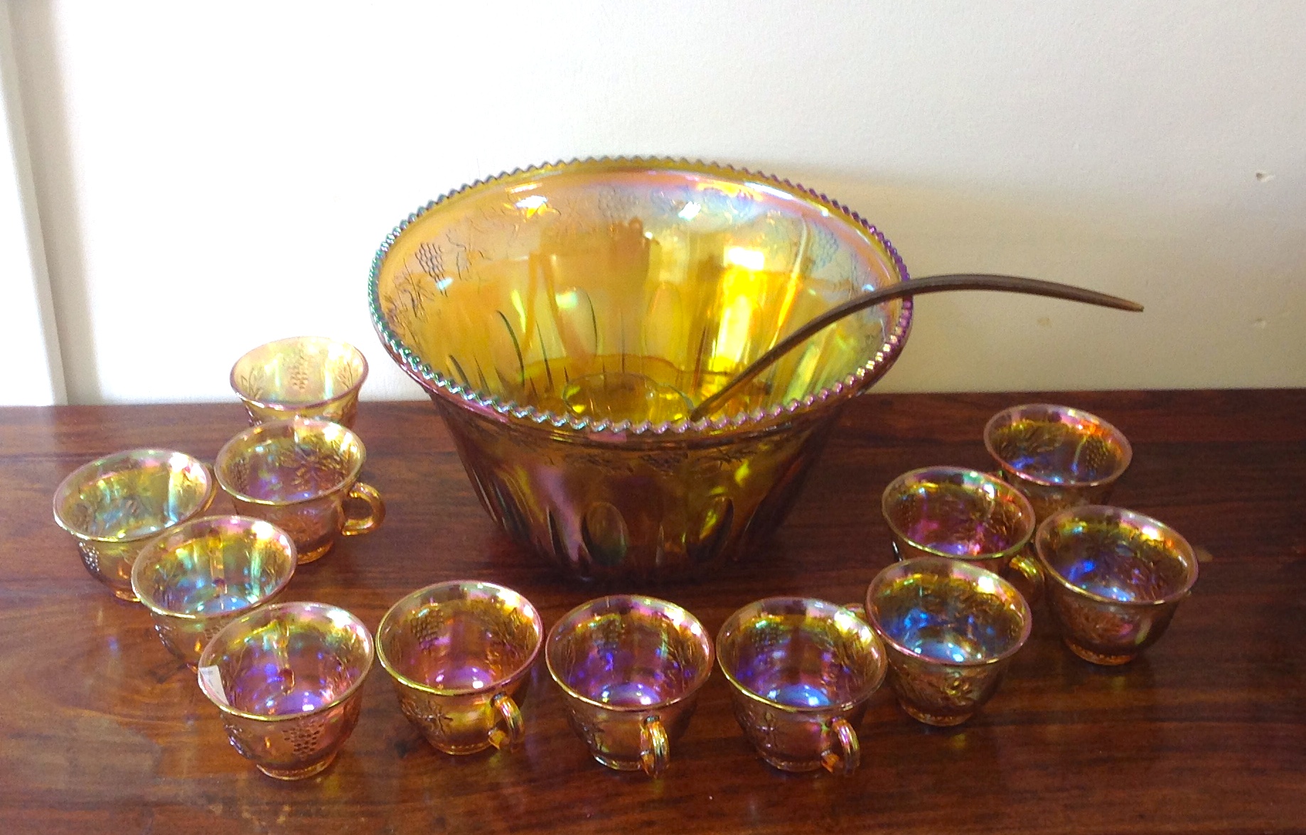 Carnival glass punch bowl and twelve gla