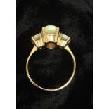 A 9 Carat Gold graduated Opal ring.