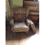 An upholstered wing back armchair, plus
