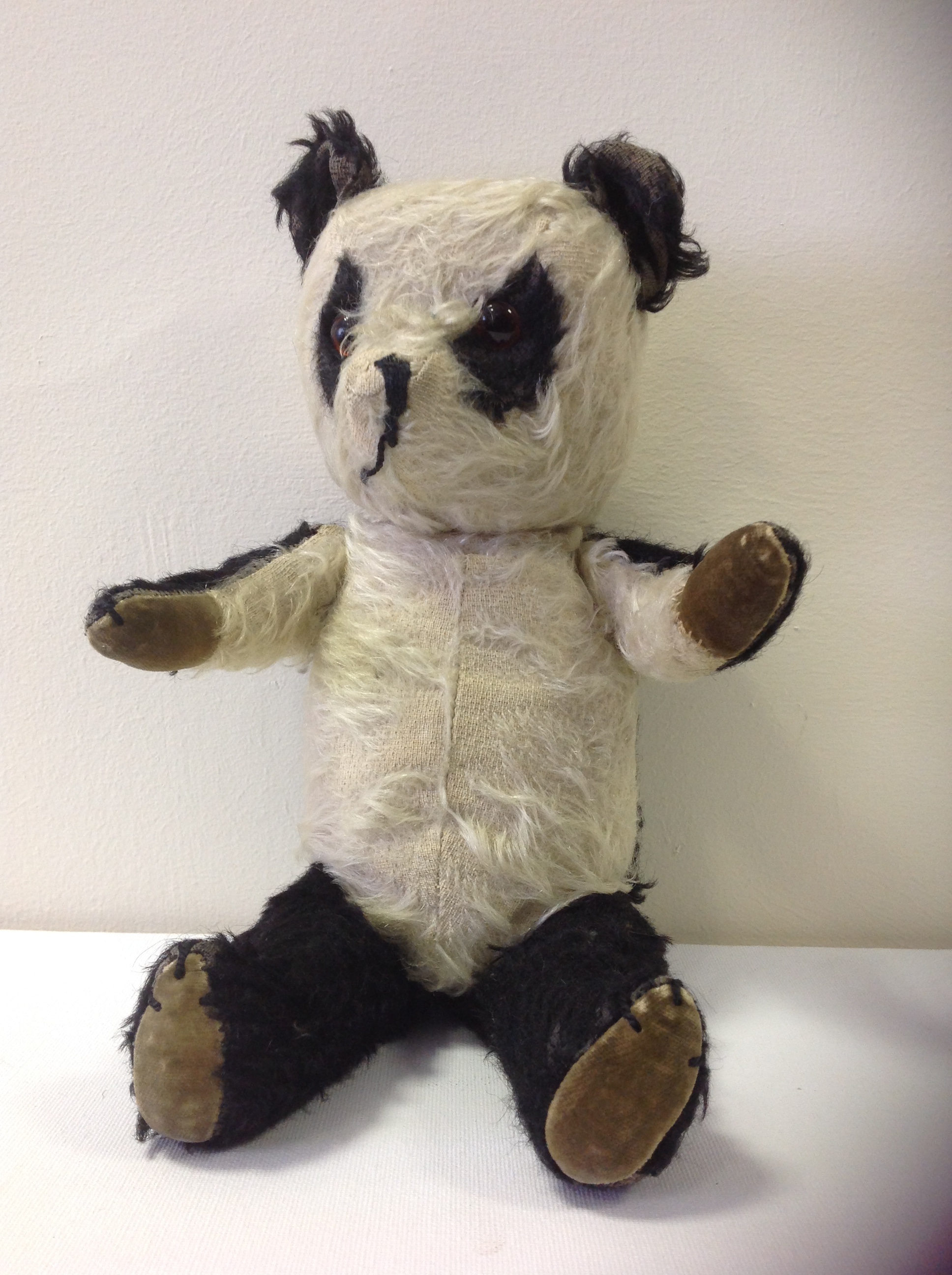 An early 20thC Mohair Panda stuffed toy.