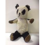 An early 20thC Mohair Panda stuffed toy.
