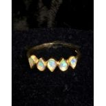 A 9 Carat Gold Opal ring, banded with 5