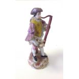 A 19thC European porcelain figure of an oboe player