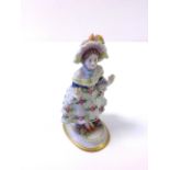 A Naples porcelain figurine of a lady.