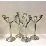 Two pairs of three-branch futuristic candlesticks