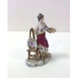 A 19thC porcelain figurine of a female artist