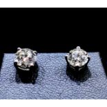A pair of 2 Carat GSL1 colour G round brilliant cut Diamond earrings with butterfly backs, in 18