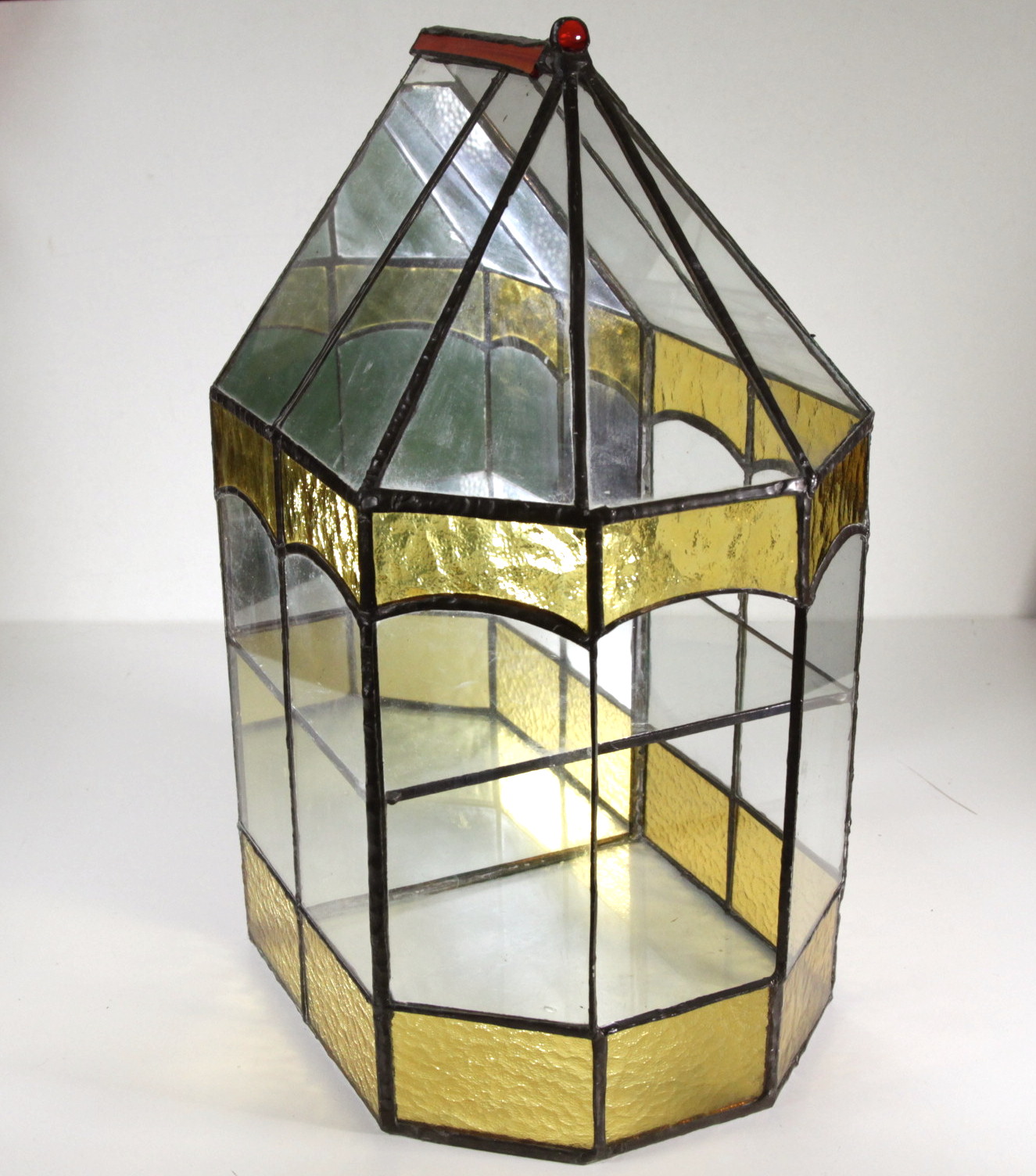 An early 20thC mirrored, stained and leaded glass, two tier plant terrarium.