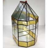 An early 20thC mirrored, stained and leaded glass, two tier plant terrarium.