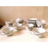 A Japanese Kutani tea set, in silver dragon design, with Geisha image in tea cup bases. (17 pcs).