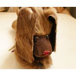 A toy dog made from cow skin and suede with metal eyes. 31cm long.