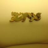 A Carved pale marbled Jade dragon. 12cm.