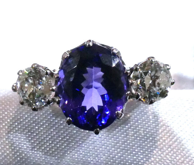 A 3.6 Carat oval Tanzanite and 1 Carat brilliant round cut Diamond ring, in 18 Carat white Gold.