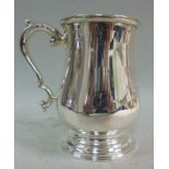 A silver one pint tankard of ogee form,