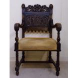 A late 19thC oak framed open arm chair,