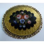 A 9ct gold oval brooch, featuring a blac