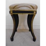A Regency black and gold painted stool,