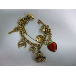 A 9ct gold kerb link charm bracelet, the