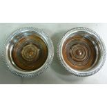 A pair of silver wine bottle coasters, e