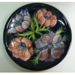 A Moorcroft pottery plate, decorated in