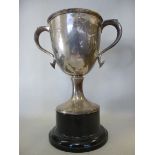 A silver trophy cup, having opposing, ho