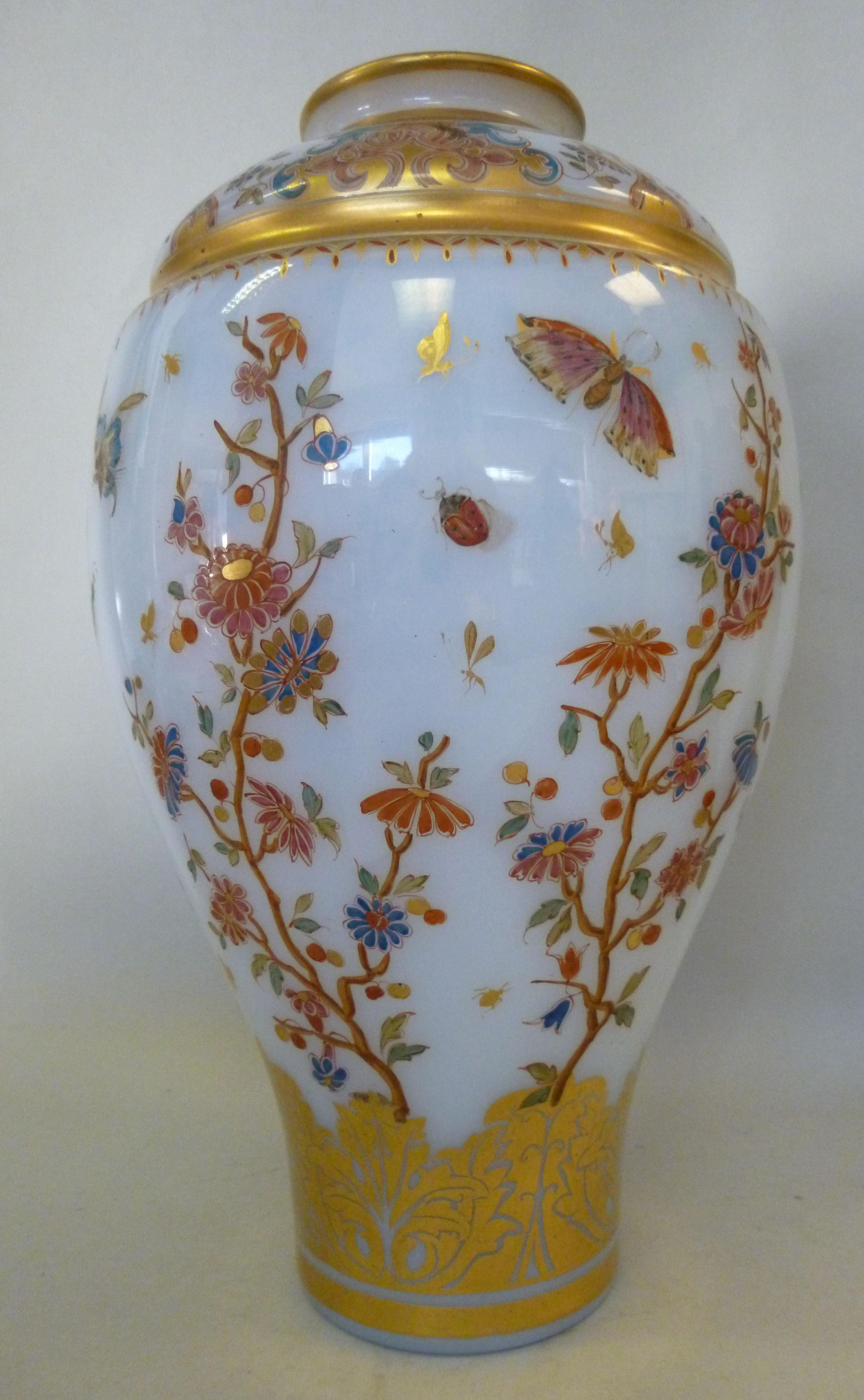 An early 20thC milk glass vase of tapere