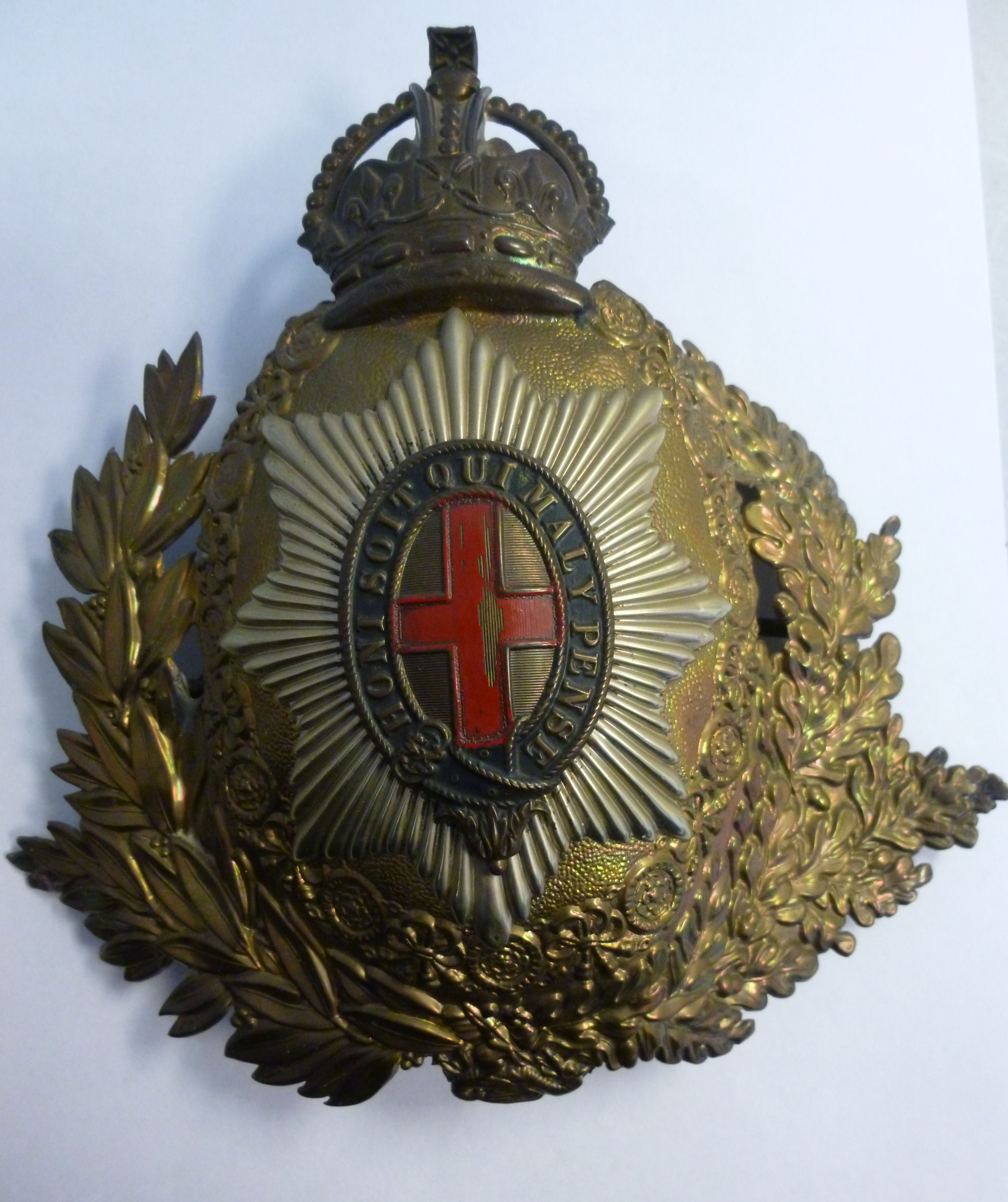 A pressed brass and white metal emblem f