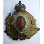 A pressed brass and white metal emblem f