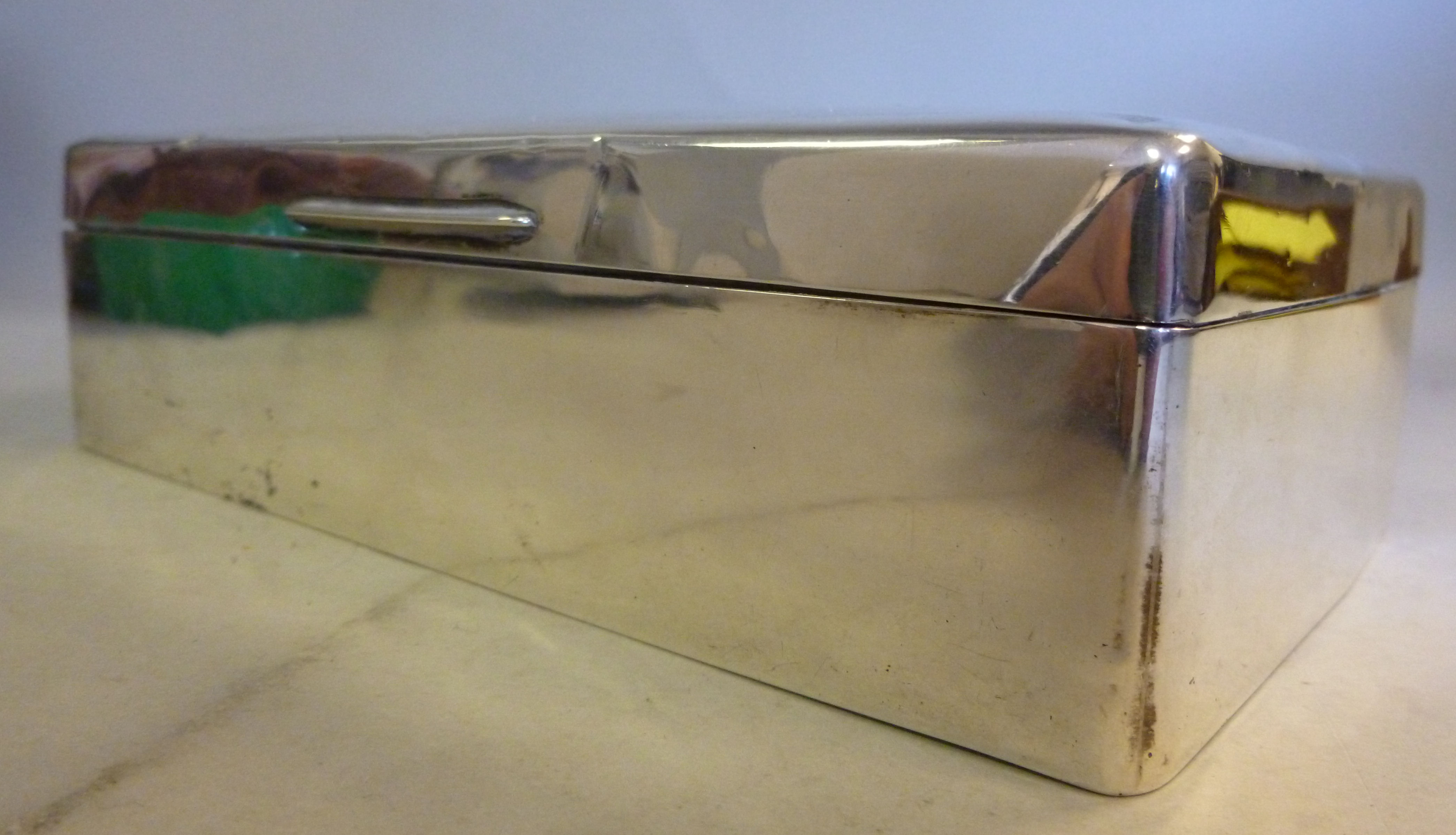 A silver cigarette box, having straight
