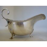 A silver sauce boat, having a gadrooned