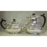 A silver teapot of bulbous form with a s