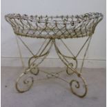 A late Victorian white painted, wire fra