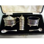 A three piece silver condiments set with