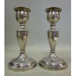 A pair of loaded silver candlesticks, ea