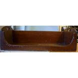 An early 20thC mahogany book trough, hav