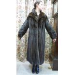 A dark brown mink coat with a lapelled c