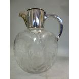 An early 20thC glass wine jug of dimpled