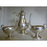 A silver coloured metal coffee pot of ov