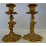 A pair of late 19thC gilt metal candlest